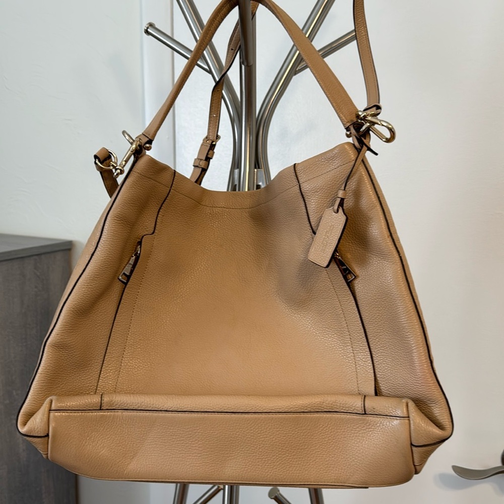 Coach light tan leather with Crossbody strap , per owned in good condition